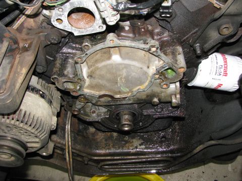 1986 Ford Bronco - now for the bottom four pan bolts. also removed oil pressure sender unit and extension.
