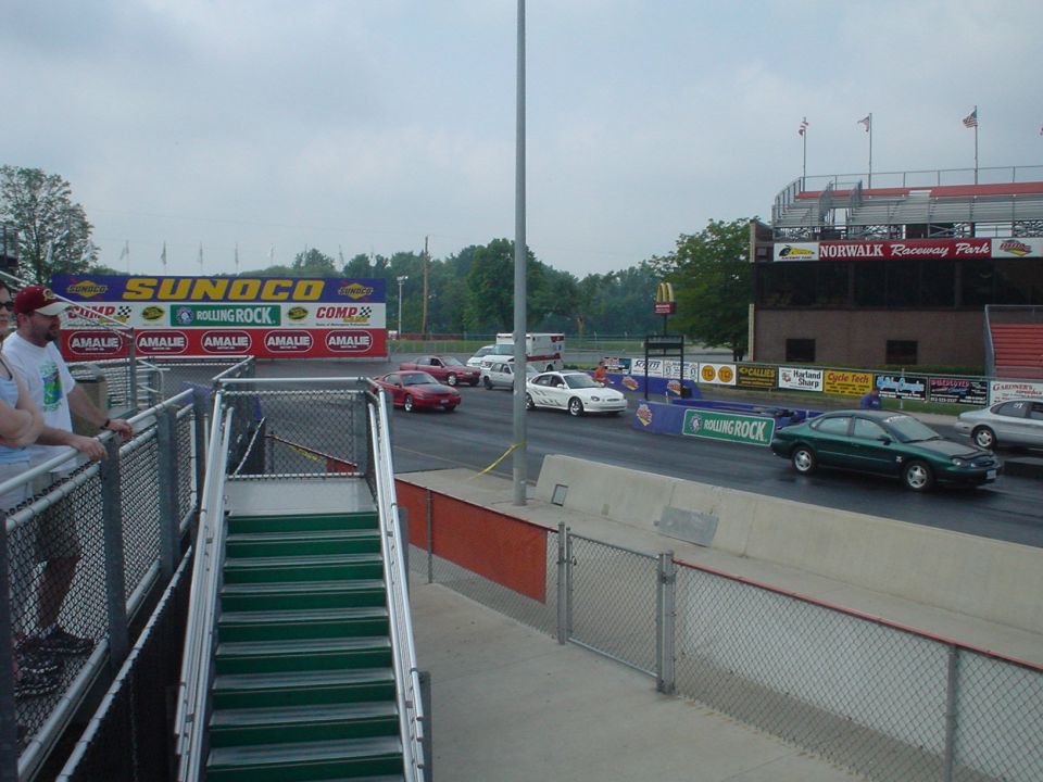 Dark green Ford Taurus sedan on the return road at Norwalk Raceway Park drag strip
