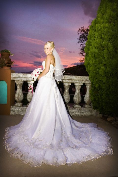 2001 Pontiac Trans Am - Bride poses for a photo on a balcony with a colorful sunset in the background.