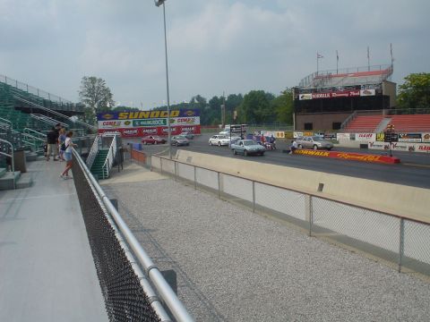 1999 Ford Taurus - Cars are staged on the drag strip at Norwalk Raceway Park under a cloudy sky.