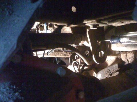 1989 Ford Bronco - Underside view of vehicle suspension components, showing mechanical linkages and mounting hardware.