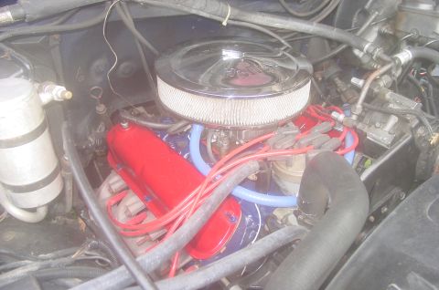 1984 Ford Bronco - Close-up view of a vehicle's engine bay, showing various components and wiring.