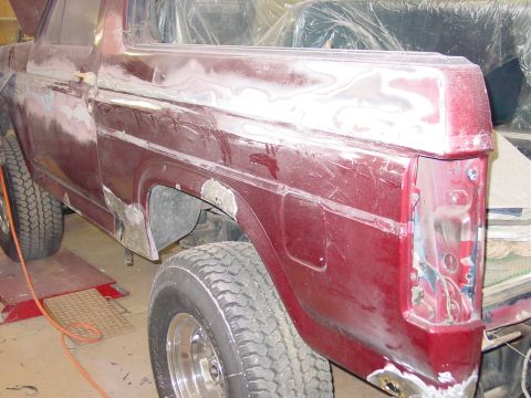 1984 Ford Bronco - This vehicle is undergoing bodywork, with visible filler and primer on the rear quarter panel and door.
