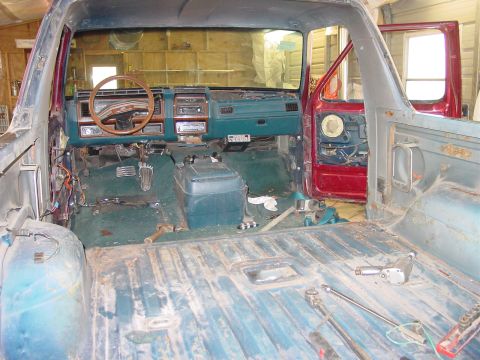 1984 Ford Bronco - The interior of a 1984 Ford Bronco shows a disassembled dashboard and floor, indicating ongoing restoration work.