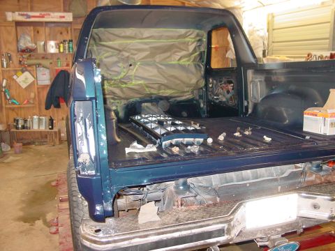 1984 Ford Bronco - The interior of a Ford Bronco is being prepped for work, with protective coverings and disassembled parts visible.