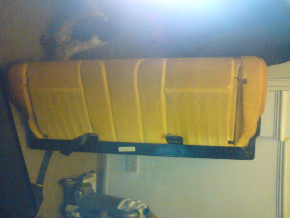 Yellow seat interior with vertical stitching and circular embossed patterns