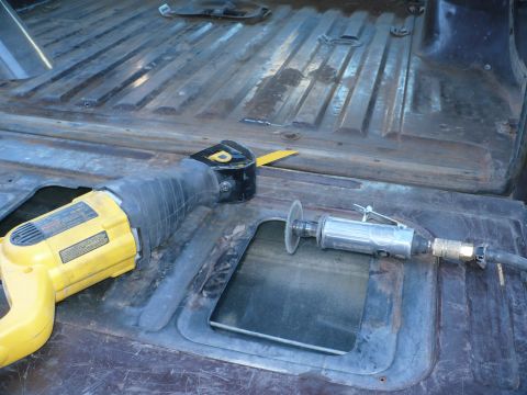 1979 Ford Bronco - Tools for metal cutting are placed on a weathered, ribbed metal surface.