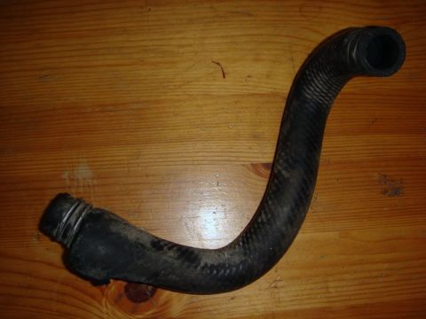 2000 Mitsubishi Montero - Automotive heater hose shown on a wooden surface.
