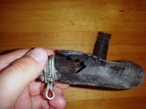 2000 Mitsubishi Montero - A damaged heater hose is shown, with a significant tear revealing internal layers and rust.