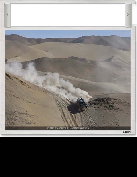 1996 Ford Bronco - A vehicle navigates a sandy terrain, creating a large dust cloud as it descends a dune.