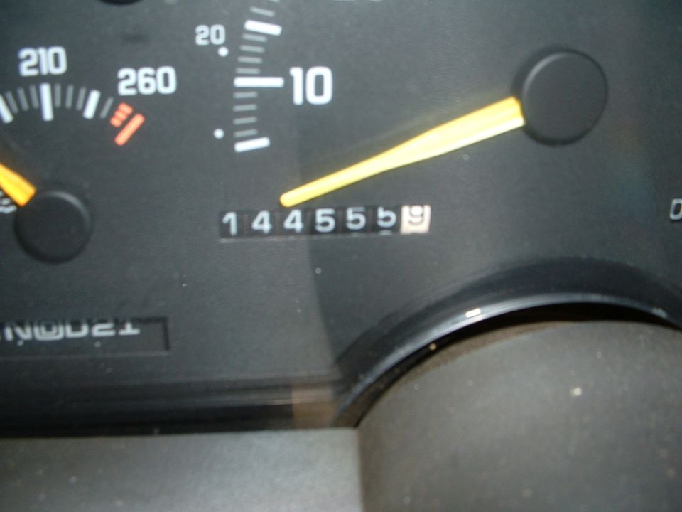 Close-up of an instrument cluster showing 144555 odometer reading