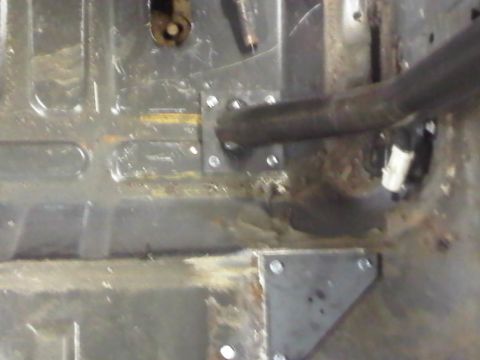 1996 Ford Bronco - Close-up view of the interior floor showing custom roll cage mounting plates and a section of the roll cage.