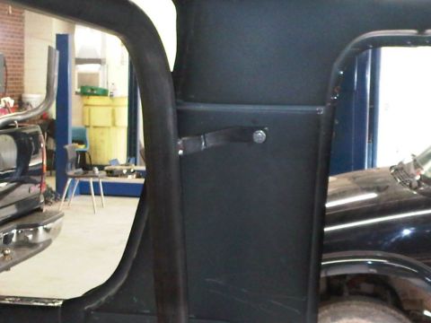 1996 Ford Bronco - Interior shot with roll cage structure and parts of two vehicles visible.