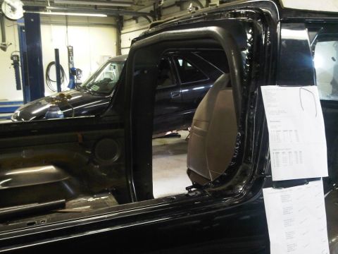 1996 Ford Bronco - Interior view of a black vehicle with a tan seat; another vehicle is in the background.