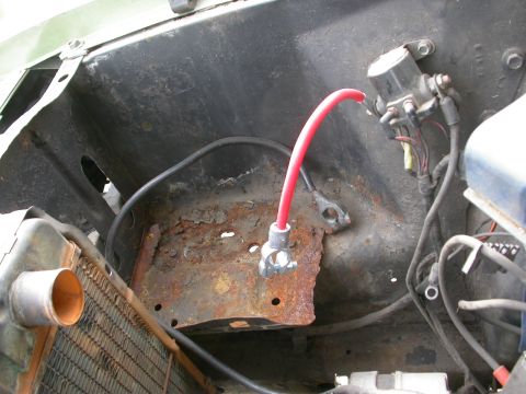 1968 Mercury Cougar - The engine bay shows significant rust around the battery tray and wiring components.