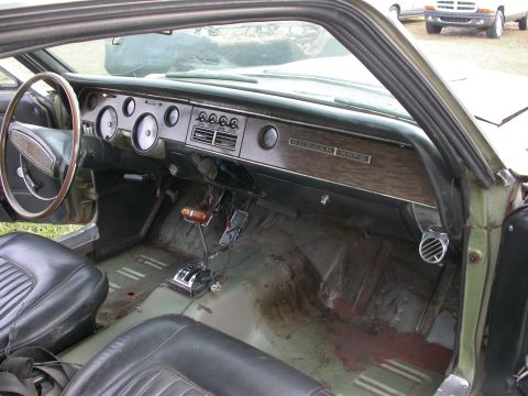 1968 Mercury Cougar - The interior of a 1968 Mercury Cougar shows its dashboard, shifter, and seats.