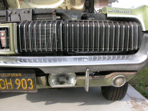 1968 Mercury Cougar - Close-up of the front end of a 1968 Mercury Cougar, highlighting its distinctive grille and chrome bumper.