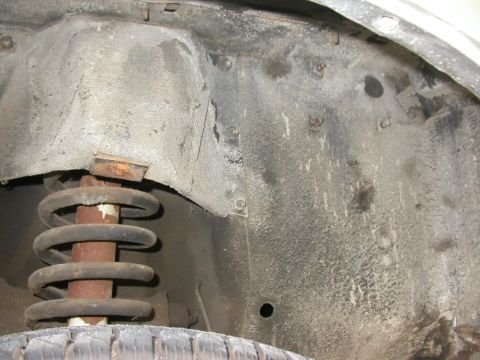 1968 Mercury Cougar - Close-up view of a vehicle's wheel well interior, showing the suspension components and undercarriage.