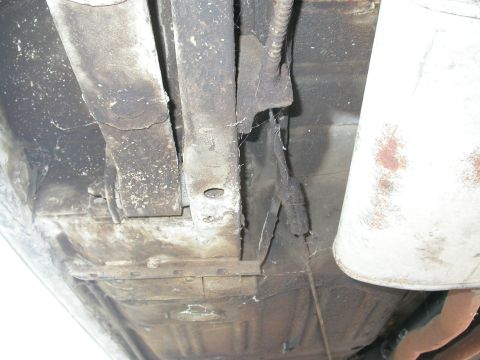 1968 Mercury Cougar - Underside view of vehicle frame and exhaust pipe, showing rust and wear.