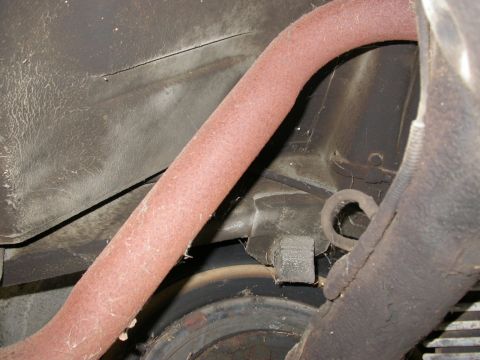 1968 Mercury Cougar - A close-up view of a vehicle's exhaust pipe and undercarriage, showing signs of wear and tear.