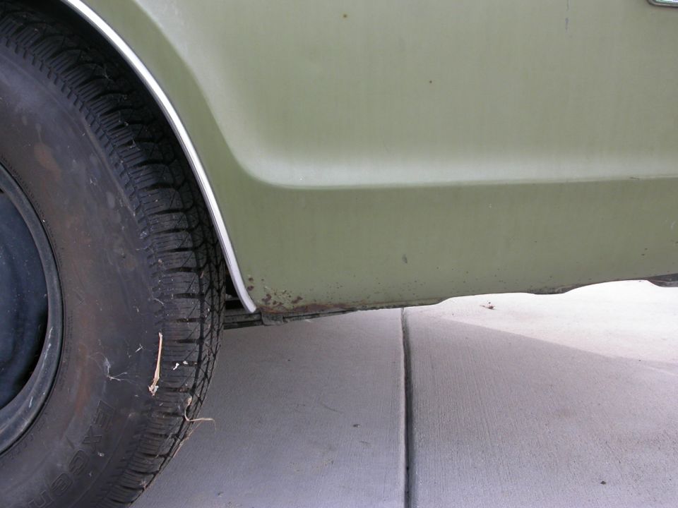 1968 Mercury Cougar rear quarter panel and tire, olive green paint with rust