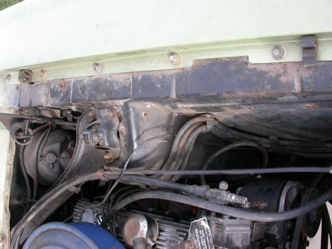 1968 Mercury Cougar - Close-up view of the engine bay of a 1968 Mercury Cougar, showing various mechanical parts and wiring.