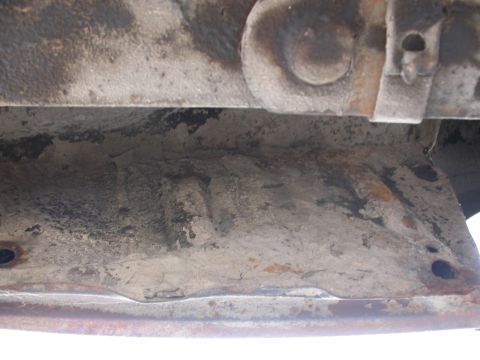1968 Mercury Cougar - Close-up view of a vehicle's undercarriage, revealing rusted metal and dirt accumulation.