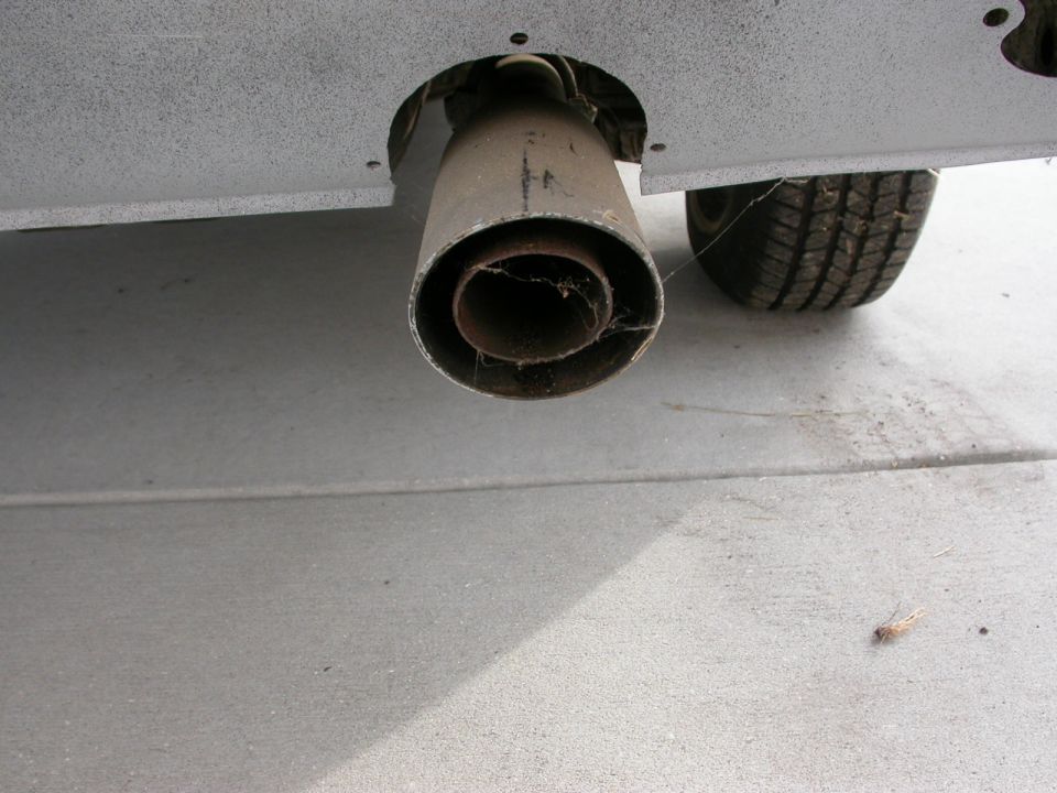 Exhaust pipe and tire on a vehicle