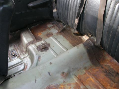1968 Mercury Cougar - The floor pan of a car exhibits extensive rust and corrosion.