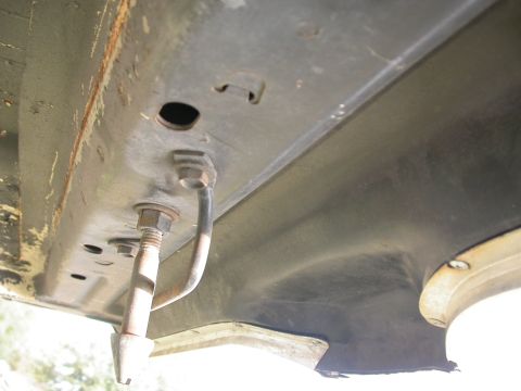 1968 Mercury Cougar - Close-up of the vehicle's undercarriage, focusing on a bolt and mounting bracket attached to the frame.