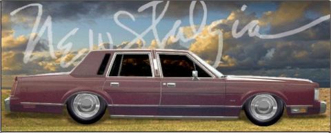 2000 Mercury Grand Marquis - Side view of a maroon sedan custom wheels and a lowered stance against a cloudy sky.
