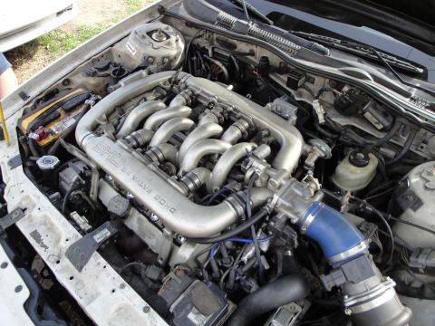 1993 Ford Taurus - Engine bay view of a Ford SHO 3.0L V6 24-valve DOHC engine, likely from a 1993 model.