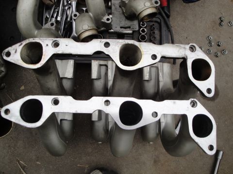 1993 Ford Taurus - Close-up of intake manifold components, likely for engine repair or modification.