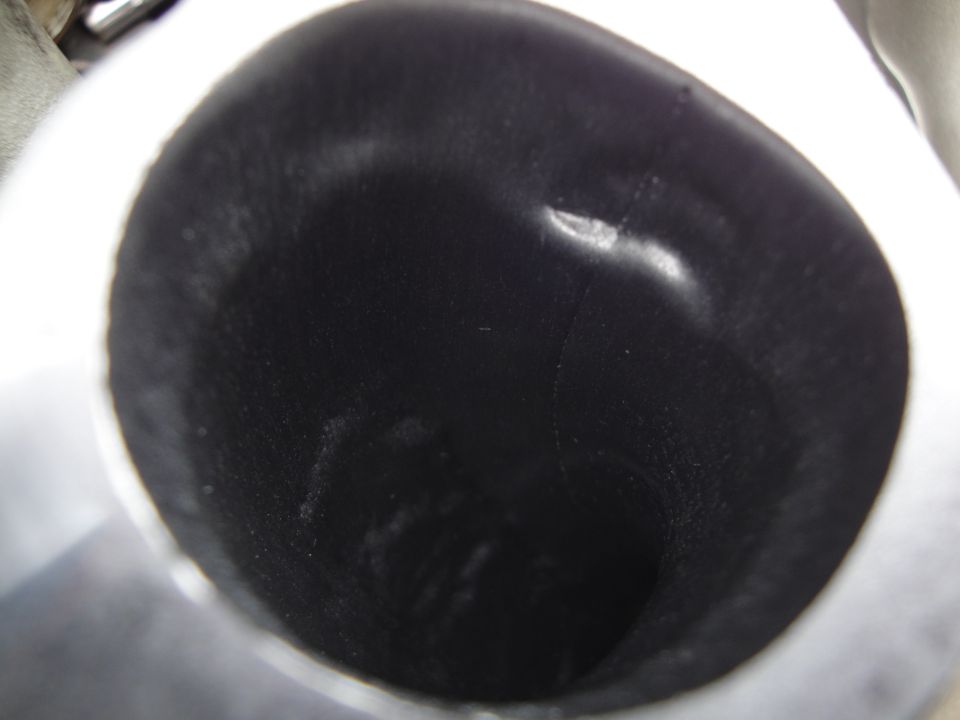 close-up of the inside of a dark, possibly dirty, exhaust pipe