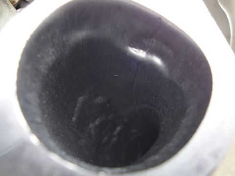 1993 Ford Taurus - Close-up view of the interior of a dark automotive part, showing signs of use.