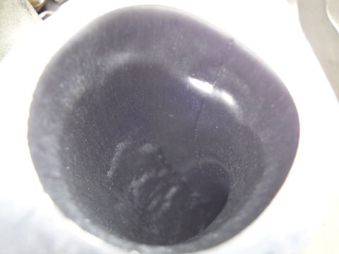 1993 Ford Taurus - The interior of an engine's intake manifold shows a dark, textured surface.