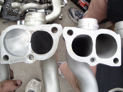 1993 Ford Taurus - Close-up view of two intake manifold parts, one of which shows a crack in its opening.