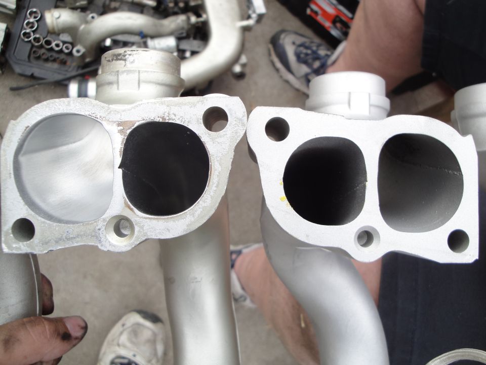 Two intake manifold parts, one with a cracked opening, are shown close-up