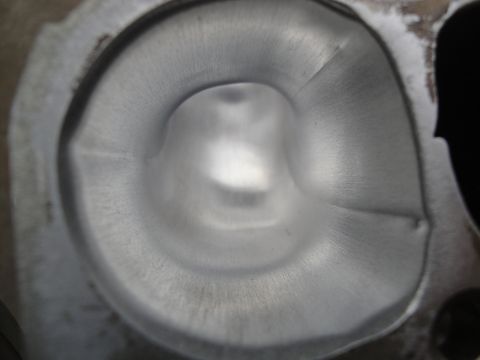 1993 Ford Taurus - A detailed view of a vehicle's cylinder head intake port, showing its internal shape and finish.