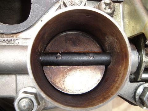 1993 Ford Taurus - A close-up view of the inside of a vehicle's throttle body, showing wear and buildup.