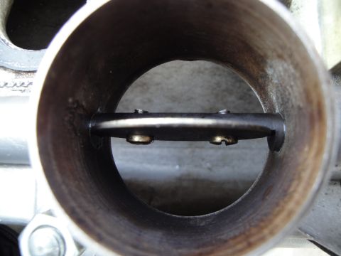 1993 Ford Taurus - Close-up view inside a throttle body, showing the butterfly valve and mounting screws.