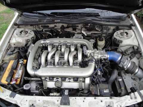 1993 Ford Taurus - Engine bay of a 1993 Ford Taurus SHO, its V6 24 valve DOHC engine and prominent SHO badging.