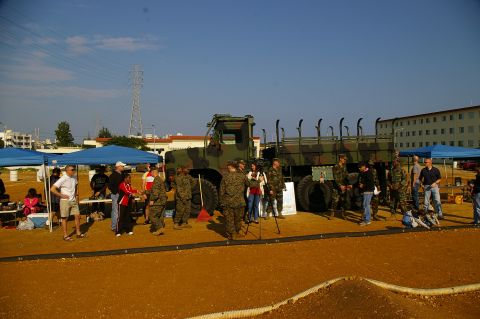 1986 Ford Bronco - A military truck is displayed outdoors with personnel gathered around it.