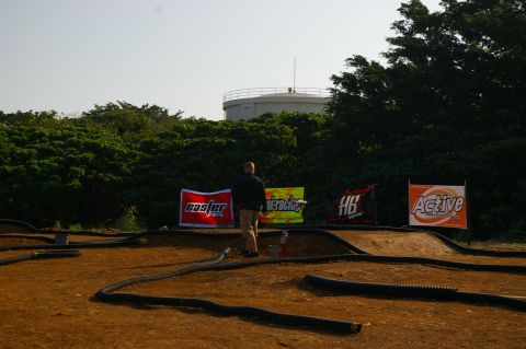 1986 Ford Bronco - RC car track setup with sponsor banners and a water tower in the distance.