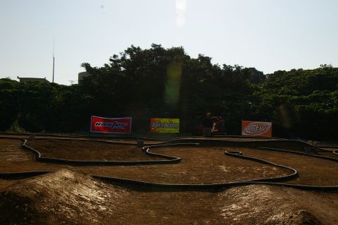 1986 Ford Bronco - Outdoor RC car track with advertising banners in the background.