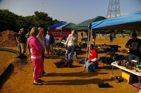 1986 Ford Bronco - An outdoor gathering features people interacting with various remote control cars and equipment under tents.