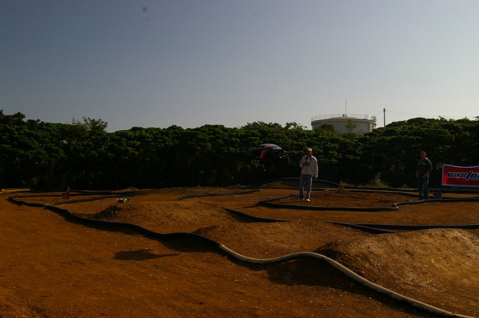 Dirt track for remote control cars with two people standing nearby