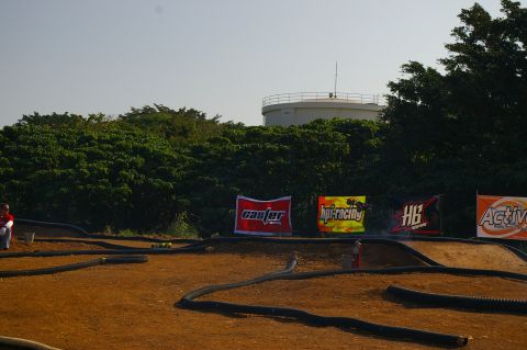 1986 Ford Bronco - An outdoor RC car track is set up with several sponsor banners visible in the background.