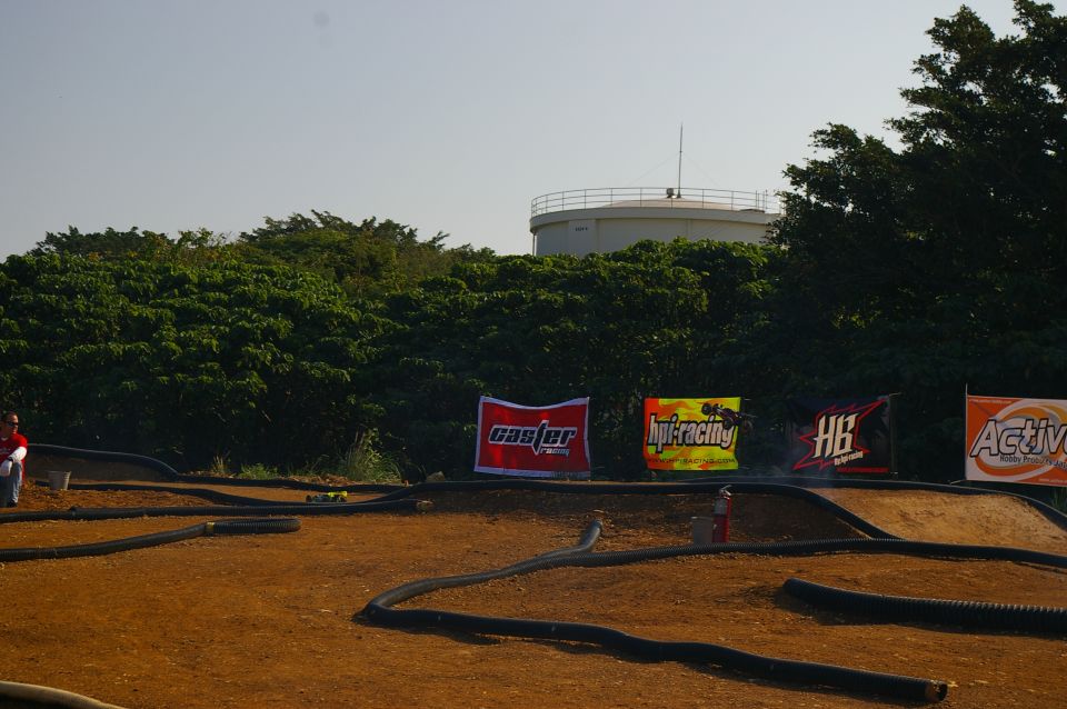 RC car track with banners for Caster, Hpi Racing, HB, and Active