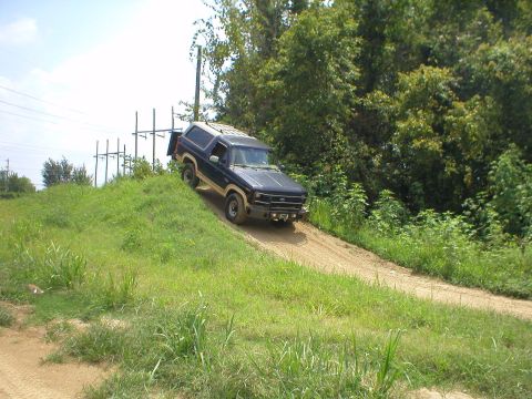1983 Ford Bronco - This 1983 Ford Bronco navigates a dirt incline, its off-road capabilities.